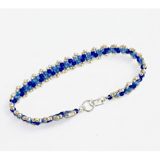 Bracelet with blue and silver beads on a white background.