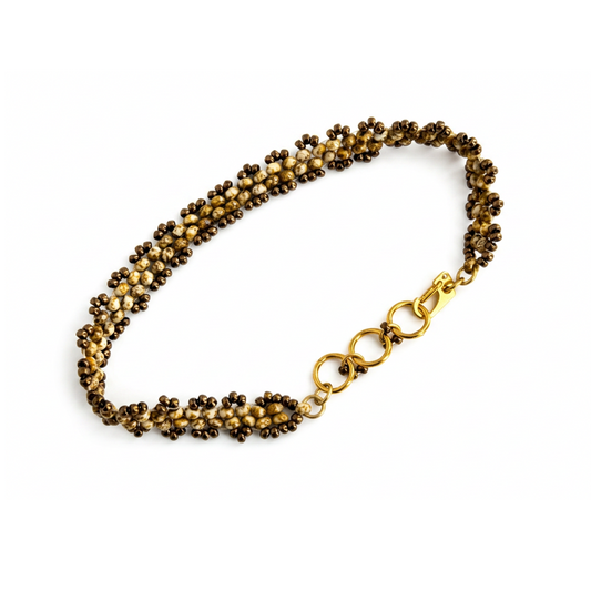 Beaded bracelet in tones of cream and bronze, with gold-plated lobster clasp