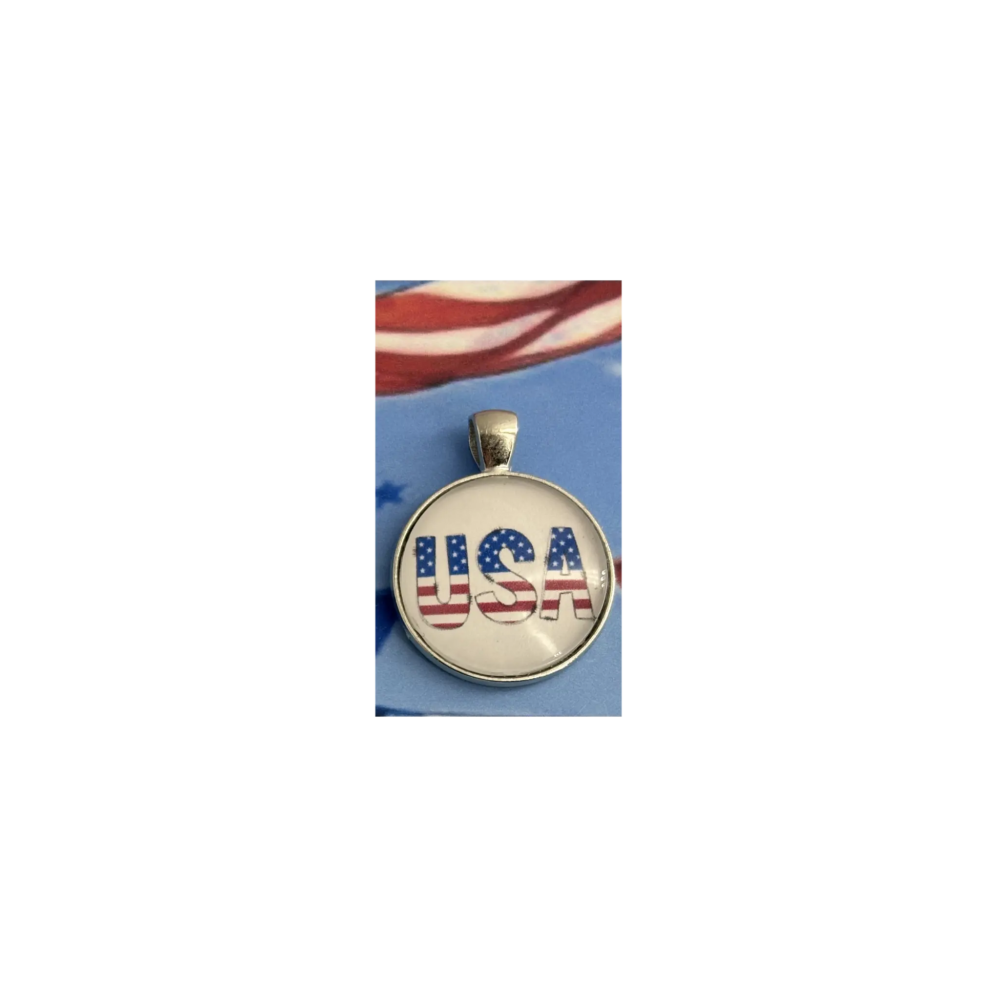 Gold pendant with 'USA' engraving on a blue background