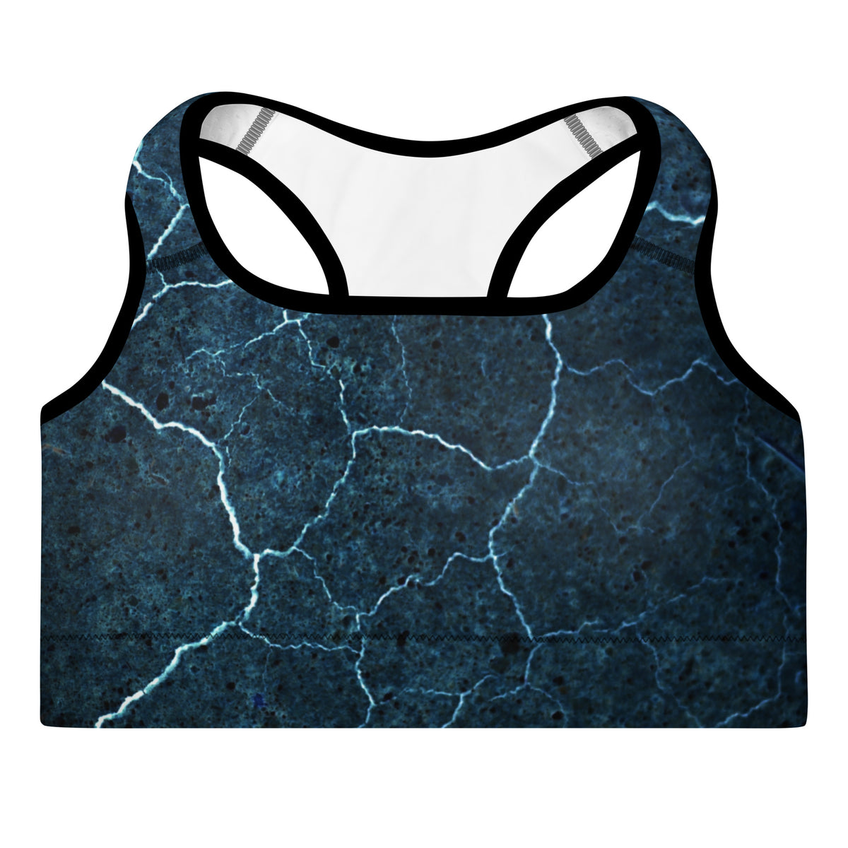 Close-up of the Indigo Illusion printed sports bra featuring the deep indigo cracked texture and wide supportive under-bust band.