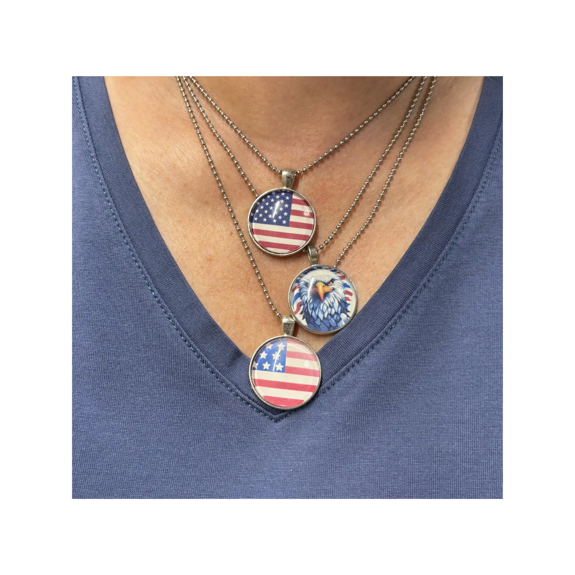 Necklace with American flag and eagle pendant on a blue shirt