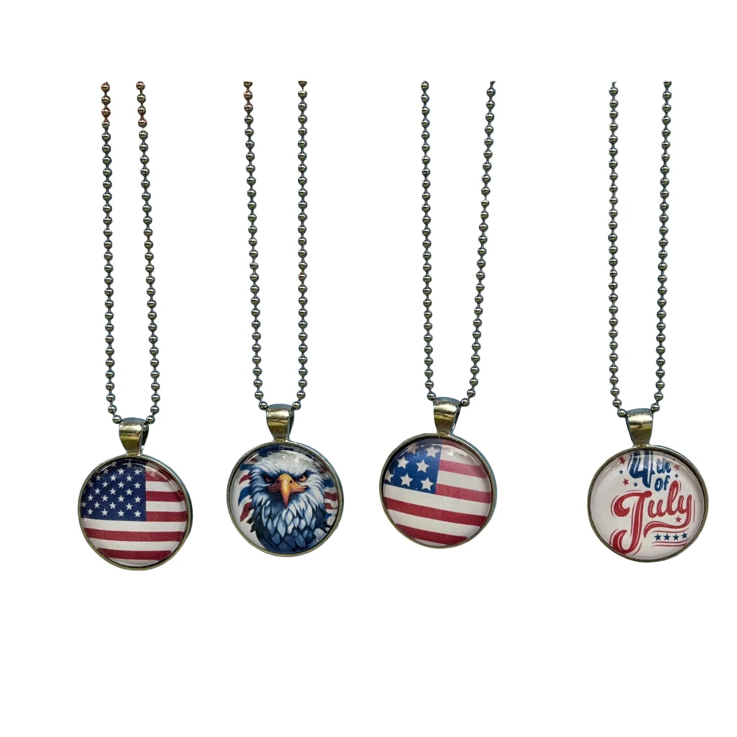 Four patriotic-themed round pendant necklaces hanging on silver chains against a white background. The pendants feature the American flag, an eagle design, and '4th of July' text.