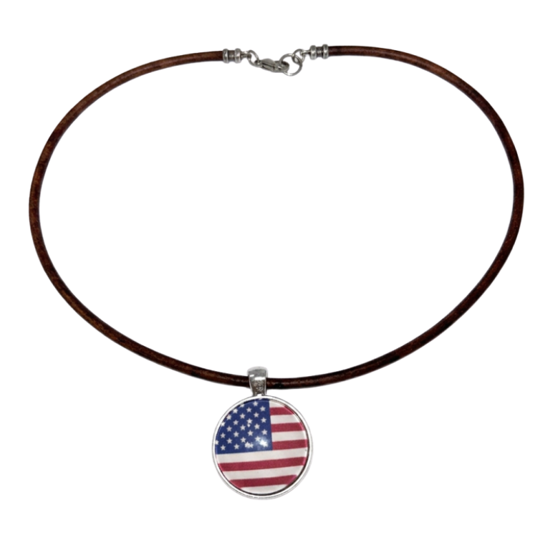 A brown leather necklace with a circular pendant featuring the American flag design, displayed on a solid white background.