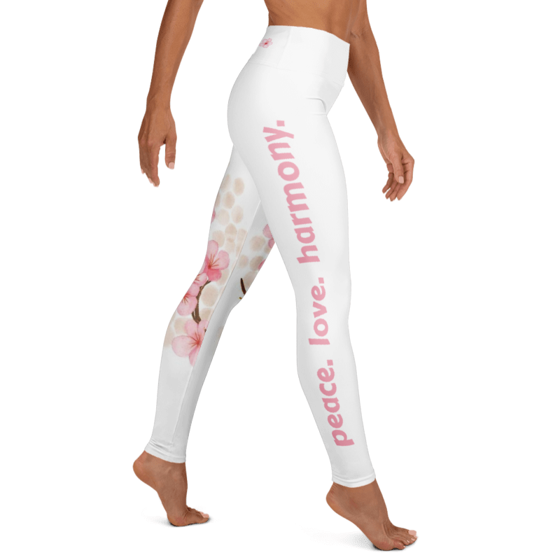 White high-waisted leggings with pink vertical text reading 'peace. love. harmony.'