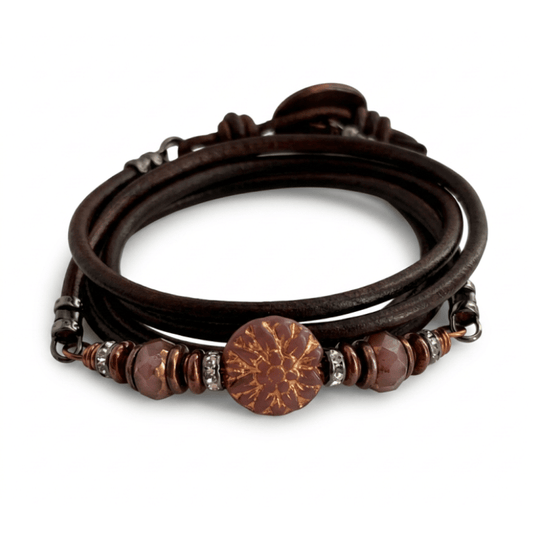 A multi-strand wrap bracelet featuring dark brown leather cords, faceted glass beads, and a prominent czech glass dahlia bead with copper accents, shown on a white background.