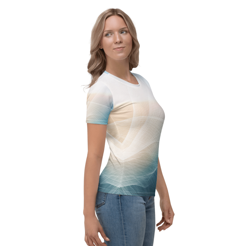 A woman modeling a short-sleeve crewneck t-shirt with a white, beige, and teal gradient abstract wave pattern, paired with blue jeans, against a plain white background.