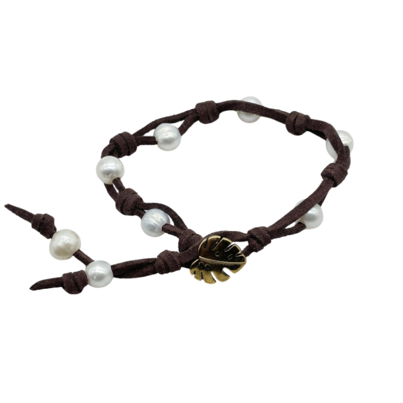 A dark brown cord bracelet featuring white pearl beads and a small gold-plated leaf button, displayed on a solid white background.