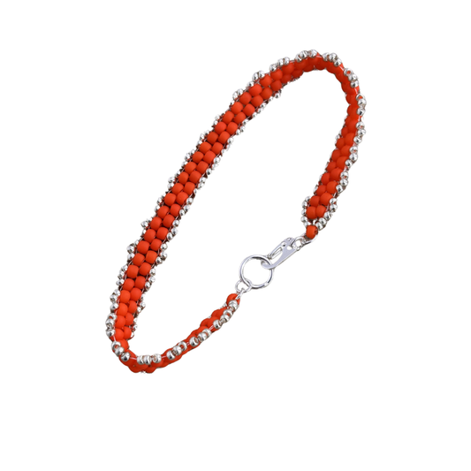 A beaded bracelet featuring vibrant orange-red beads alternating with small silver metallic beads, finished with a silver lobster clasp, shown on a plain white background.