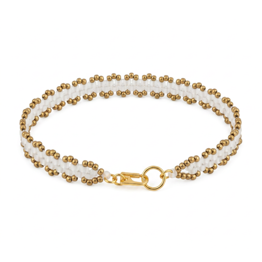 A double-row beaded bracelet featuring white and bronze beads, secured with a gold lobster clasp and ring.
