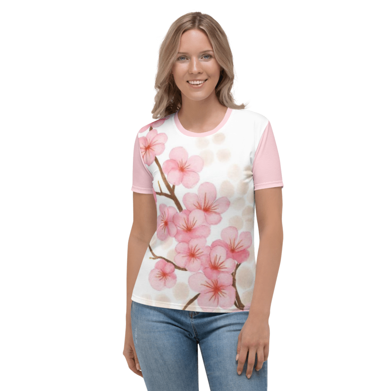 A smiling woman wearing the Sakura Soul regular-fit t-shirt featuring a watercolor cherry blossom branch graphic on a white background with pink sleeves.