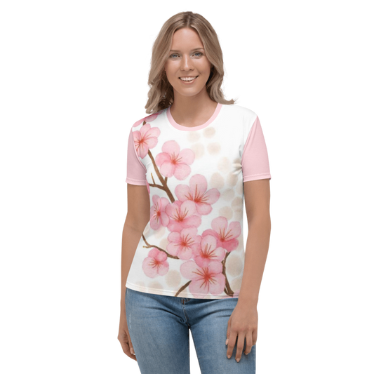 A smiling woman wearing the Sakura Soul regular-fit t-shirt featuring a watercolor cherry blossom branch graphic on a white background with pink sleeves.