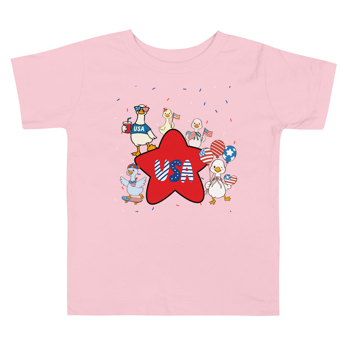 A pink short-sleeve jersey t-shirt features a fun, festive print of patriotic ducks, twinkling stars, and exploding confetti on a white background.