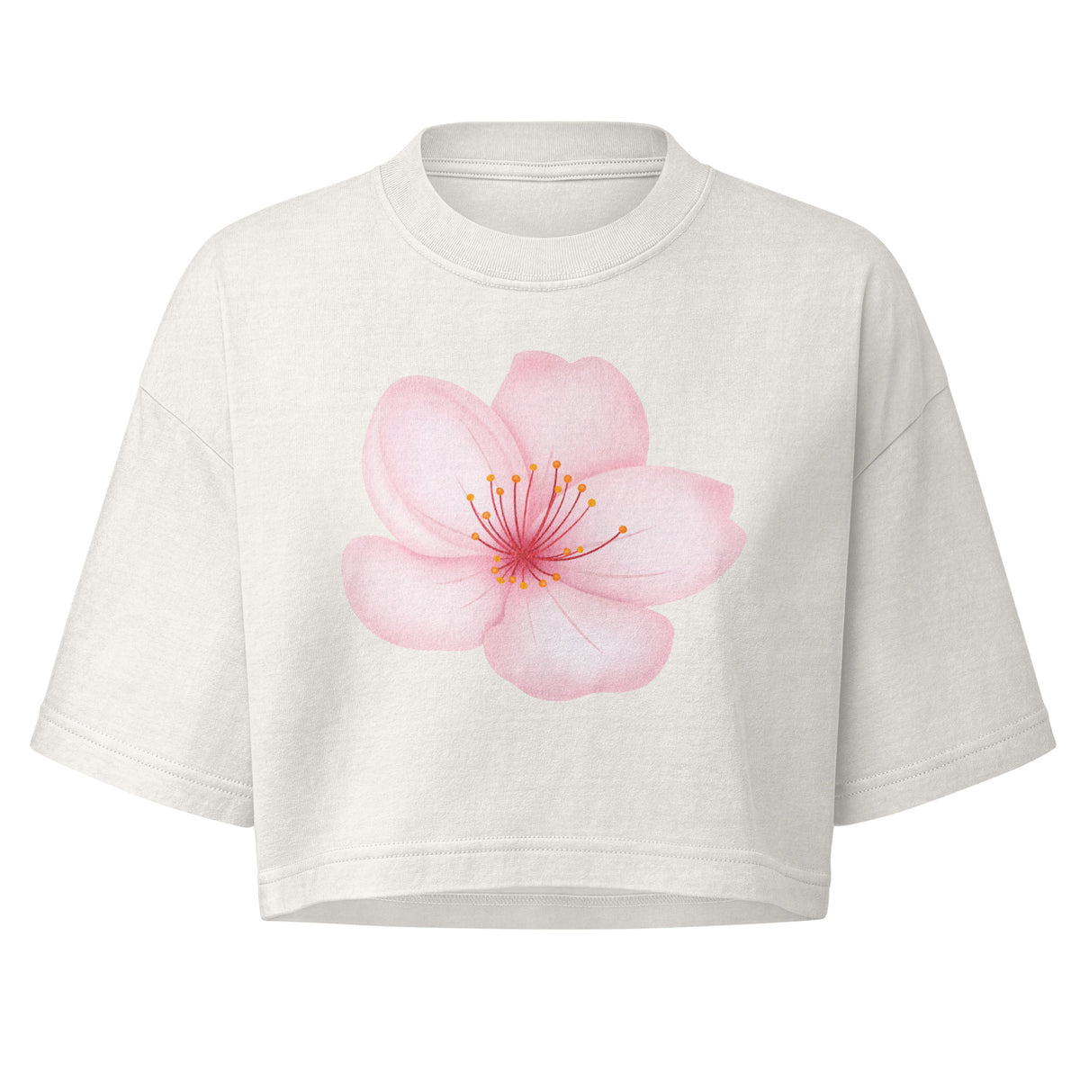 A light cream-colored short-sleeve crop top featuring a large, detailed graphic of a pink cherry blossom flower with yellow-orange stamens printed on the chest, displayed against a solid white background.