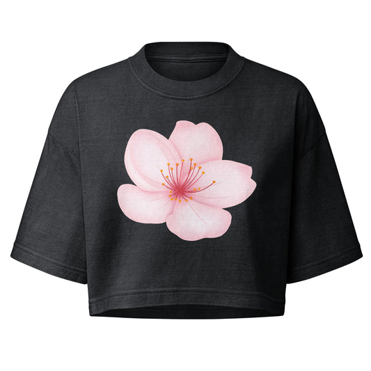 A dark charcoal gray cropped t-shirt featuring a large, detailed pink cherry blossom graphic on the front, displayed against a solid white background.